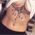 Женские татуировки на груди 11