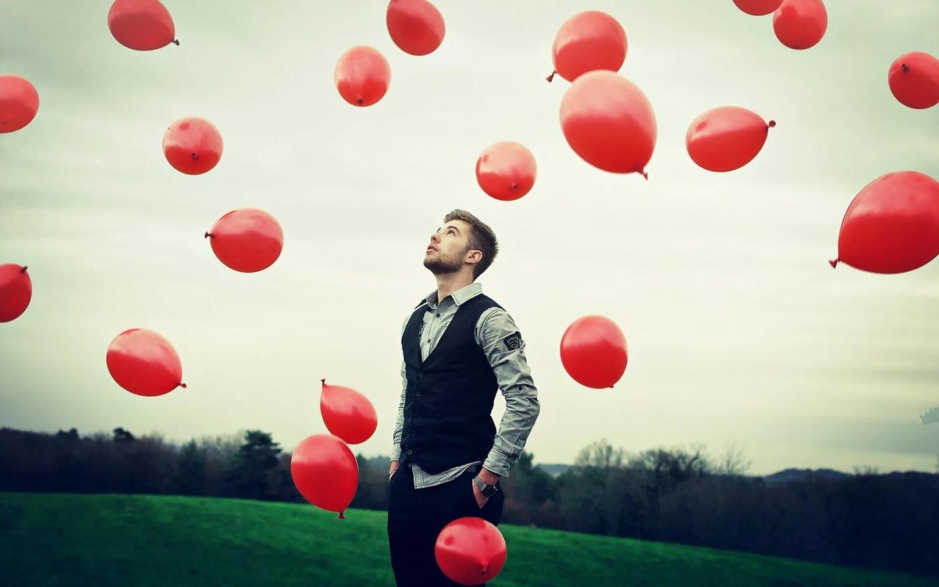 Мужчина держит воздушные шары в воздухе 9